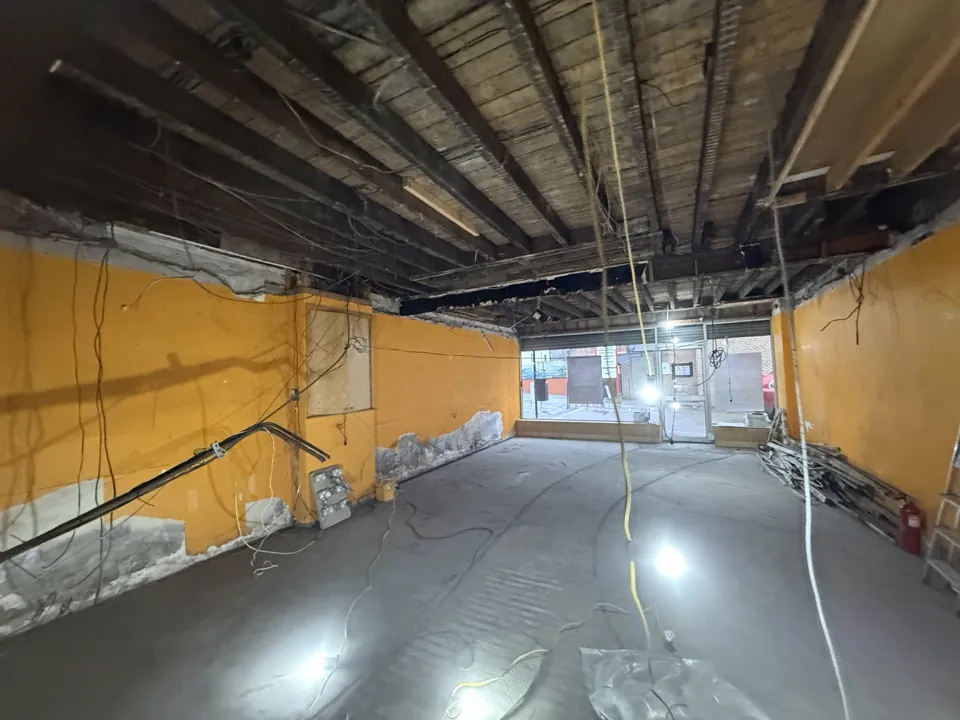 Commercial interior during a D&M job, showing exposed ceiling structure